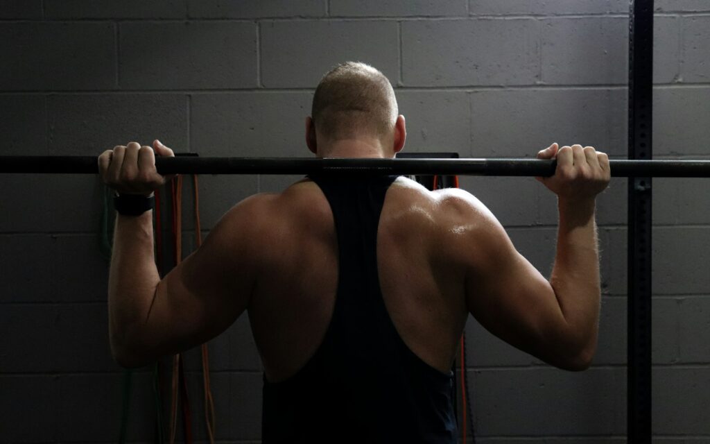 A man lifting weights in a gym, representing strength and fitness