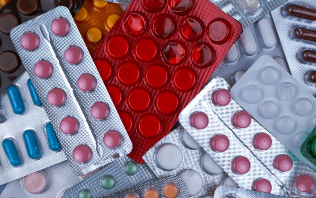 Colorful blister packs of medication representing drug repurposing