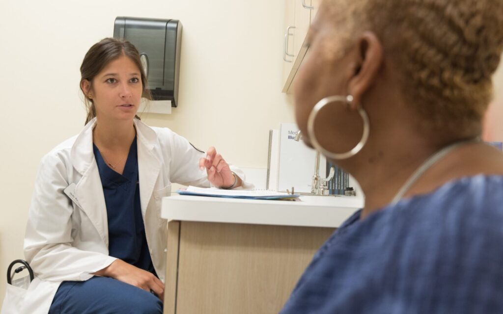 Doctor consulting with a female patient during a clinic visit