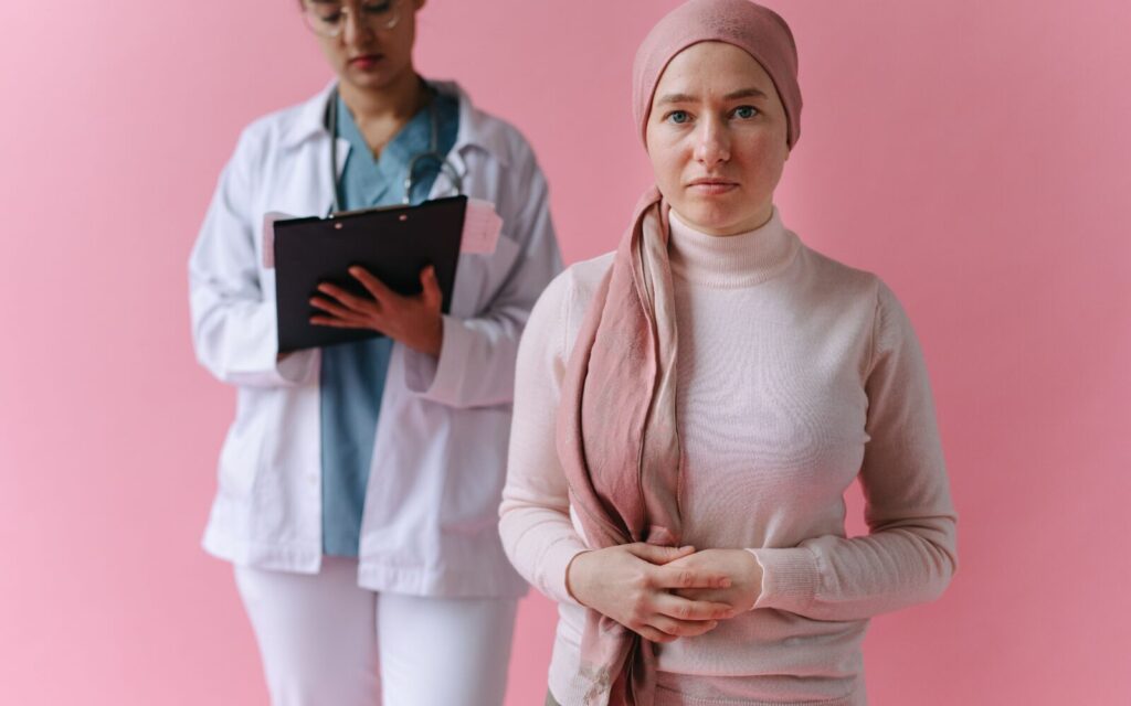 Oncology clinician supporting an adult woman during breast cancer treatment